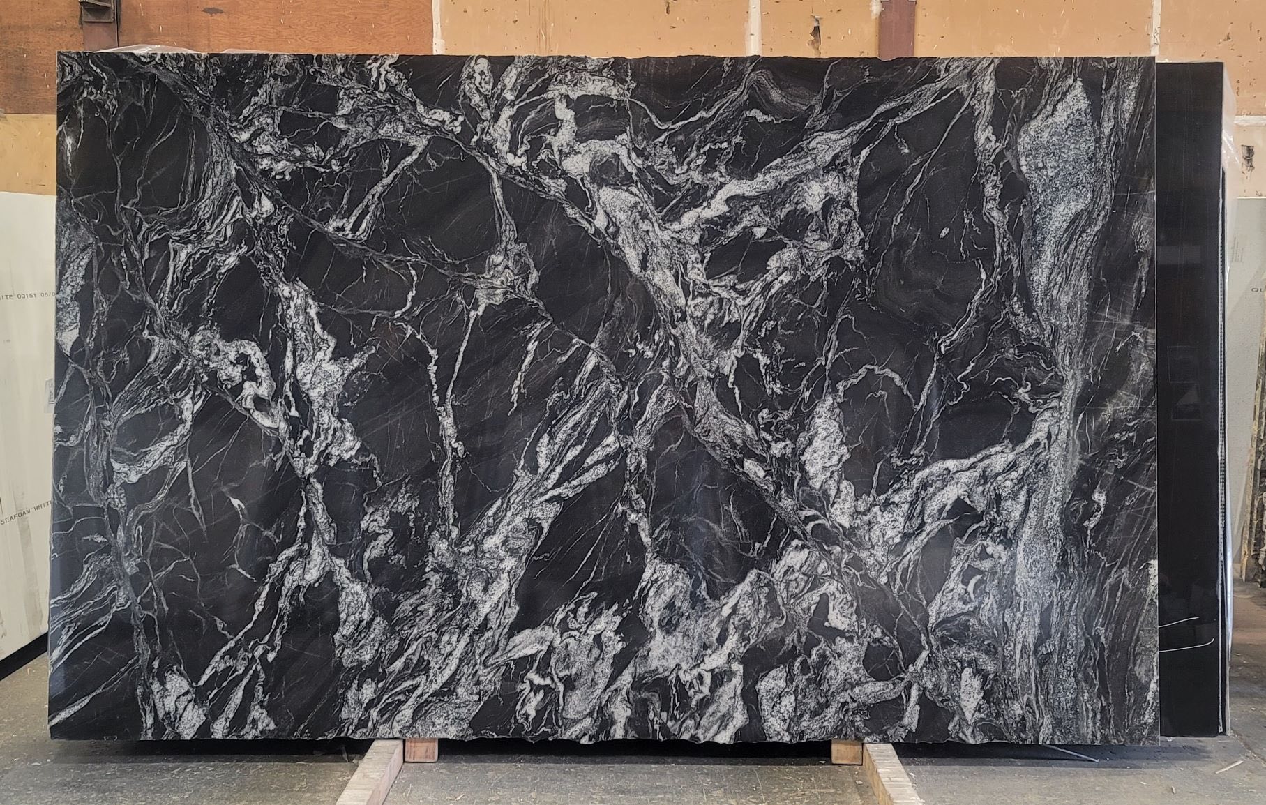 Black granite slab with bold white veining throughout.