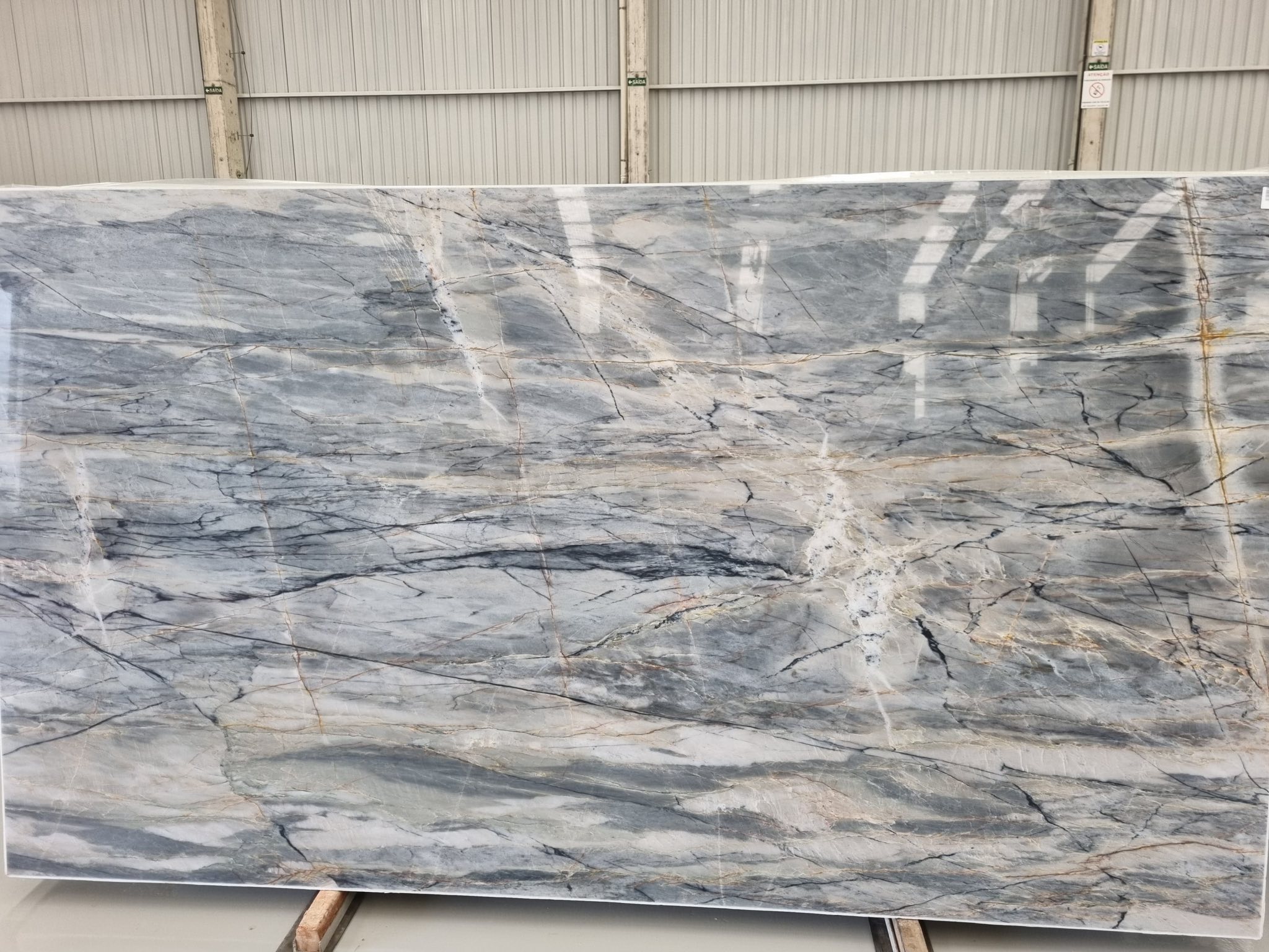Grey and beige quartzite slab with delicate movement at the warehouse.